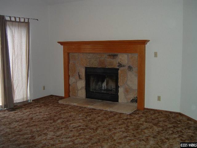 6052 Walnut Creek Road Reno, NV 89523 - Photo 2 of 5 a living room with a fireplace