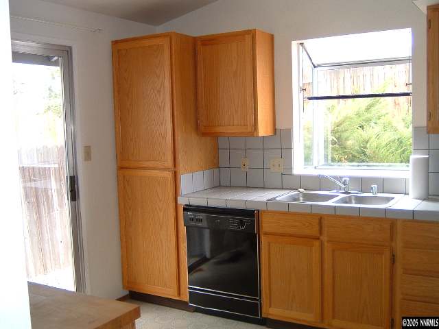 6052 Walnut Creek Road Reno, NV 89523 - Photo 4 of 5 a kitchen with a sink a window and cabinets