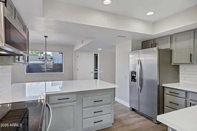 a kitchen with a sink stove and microwave