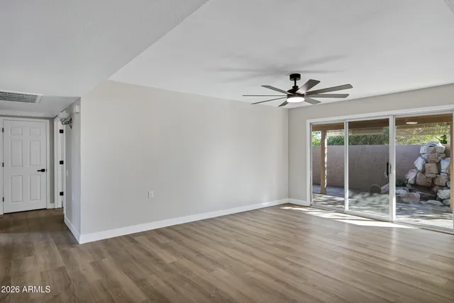 wooden floor in an empty room with a window