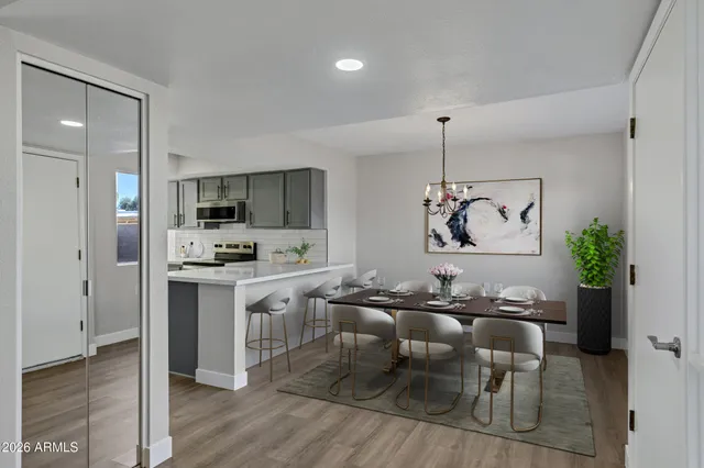 a kitchen with kitchen island a counter top space a sink stainless steel appliances and cabinets