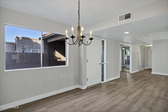 a large kitchen with granite countertop a large counter top a sink and stainless steel appliances