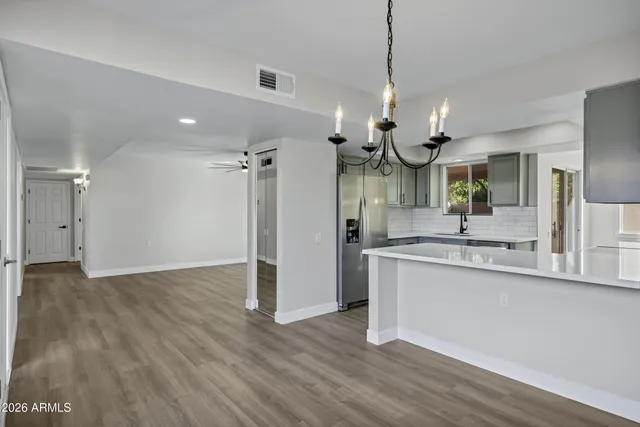 a kitchen with a sink a counter top space stainless steel appliances and cabinets