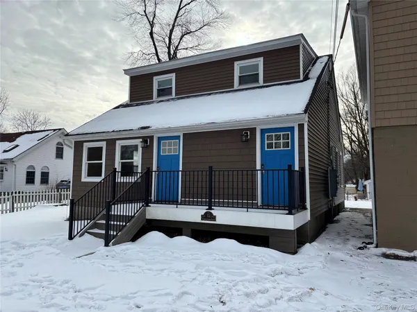 a house view with a sitting space and wooden fence