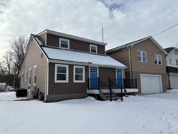 a view of a house with a yard and garage