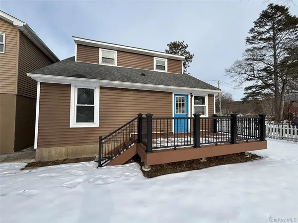a view of a house with a wooden fence