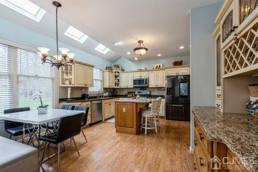 11 Tree Farm Road Monmouth Junction, NJ 08852 - Photo 11 of 27 a kitchen with a dining table chairs and refrigerator