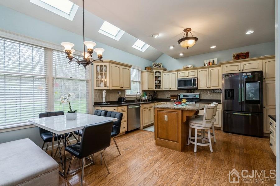 11 Tree Farm Road Monmouth Junction, NJ 08852 - Photo 12 of 27 a kitchen with a dining table chairs stainless steel appliances and cabinets
