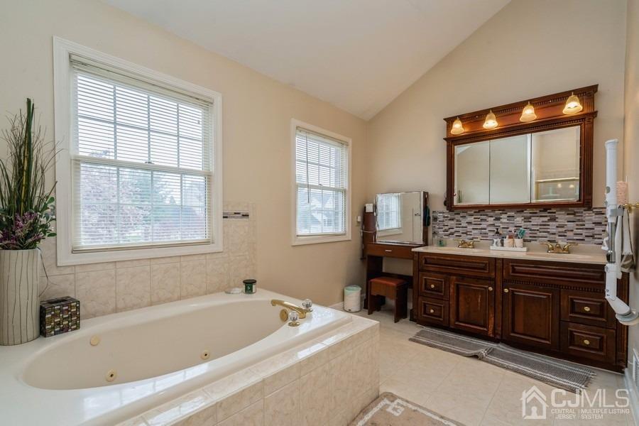 11 Tree Farm Road Monmouth Junction, NJ 08852 - Photo 19 of 27 a bathroom with a bathtub sink and mirror
