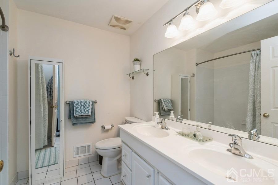 11 Tree Farm Road Monmouth Junction, NJ 08852 - Photo 24 of 27 a bathroom with a toilet a sink and a mirror