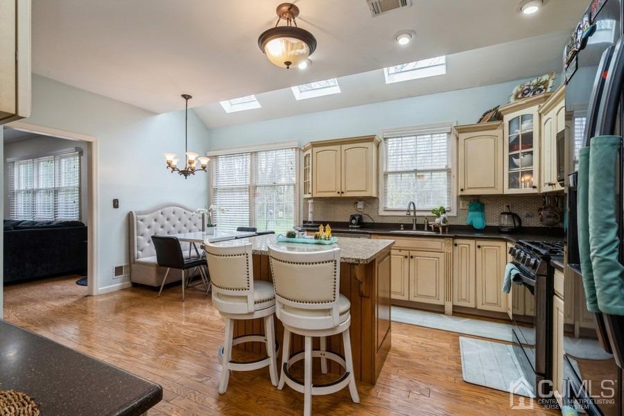 11 Tree Farm Road Monmouth Junction, NJ 08852 - Photo 10 of 27 a kitchen with a table chairs stove and cabinets