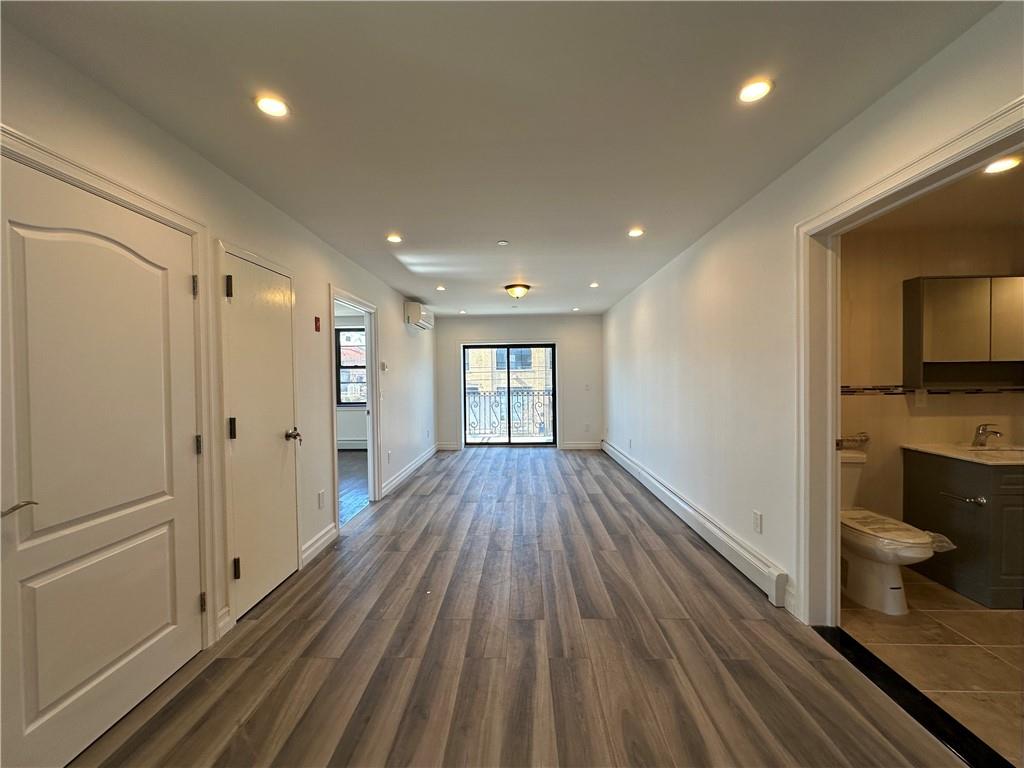 1307 84th Street, Unit 2B Brooklyn, NY 11228 - Photo 17 of 18 a view of a hallway with wooden floor and staircase