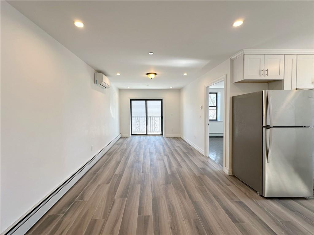 1307 84th Street, Unit 2B Brooklyn, NY 11228 - Photo 2 of 18 a view of a kitchen with a refrigerator and wooden floor