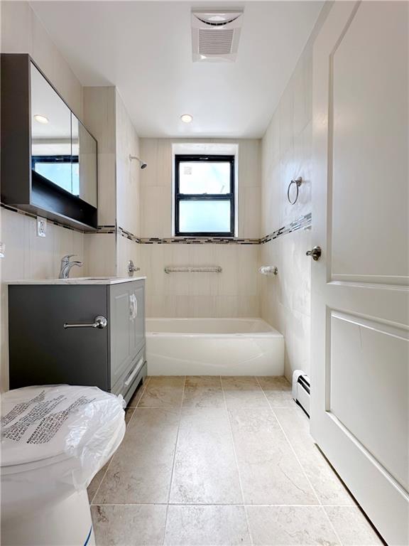 1307 84th Street, Unit 2B Brooklyn, NY 11228 - Photo 6 of 18 a spacious bathroom with a tub sink and mirror
