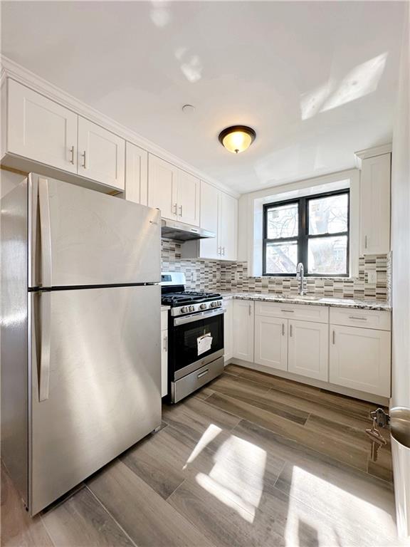 1307 84th Street, Unit 2B Brooklyn, NY 11228 - Photo 7 of 18 a kitchen with white cabinets and white appliances
