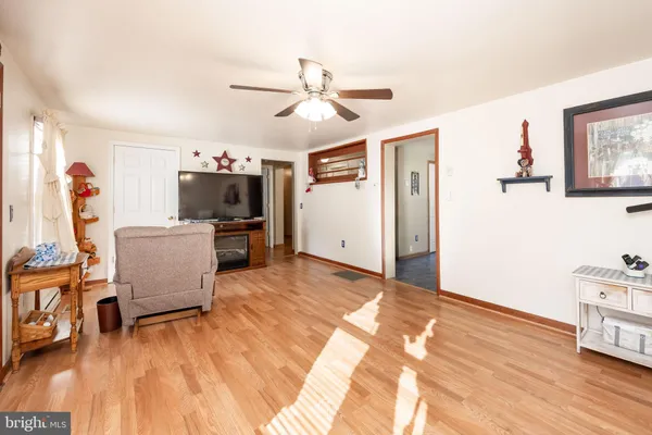 a view of a workspace with furniture and wooden floor