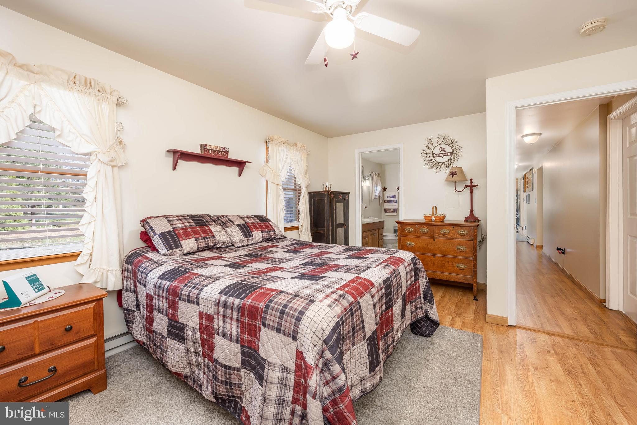 911 Outten Road Salisbury, MD 21804 - Photo 14 of 36 a bedroom with a bed and a chandelier