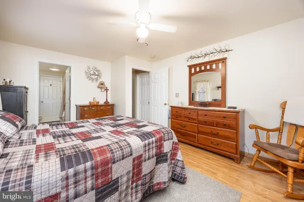 a bedroom with a bed and a dresser in it
