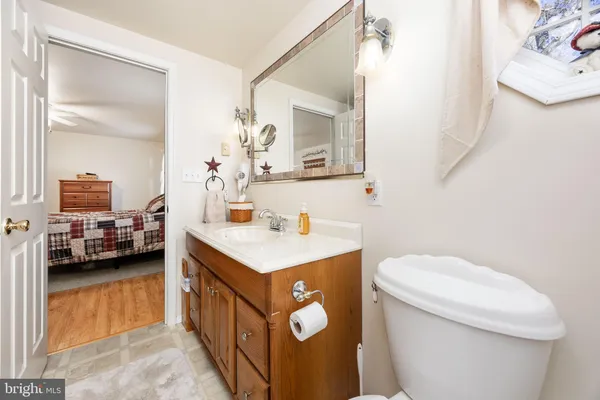 a bathroom with a toilet sink and mirror