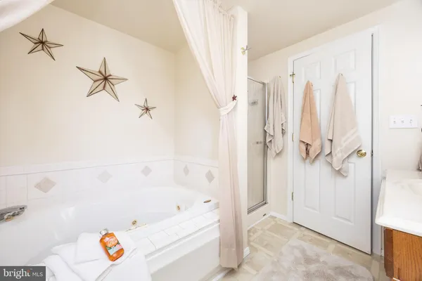 a bathroom with a bathtub and a shower