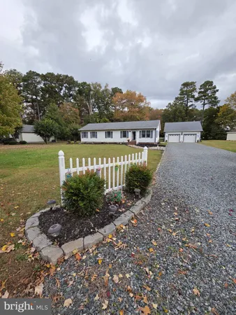 a view of a house with a garden and lake view