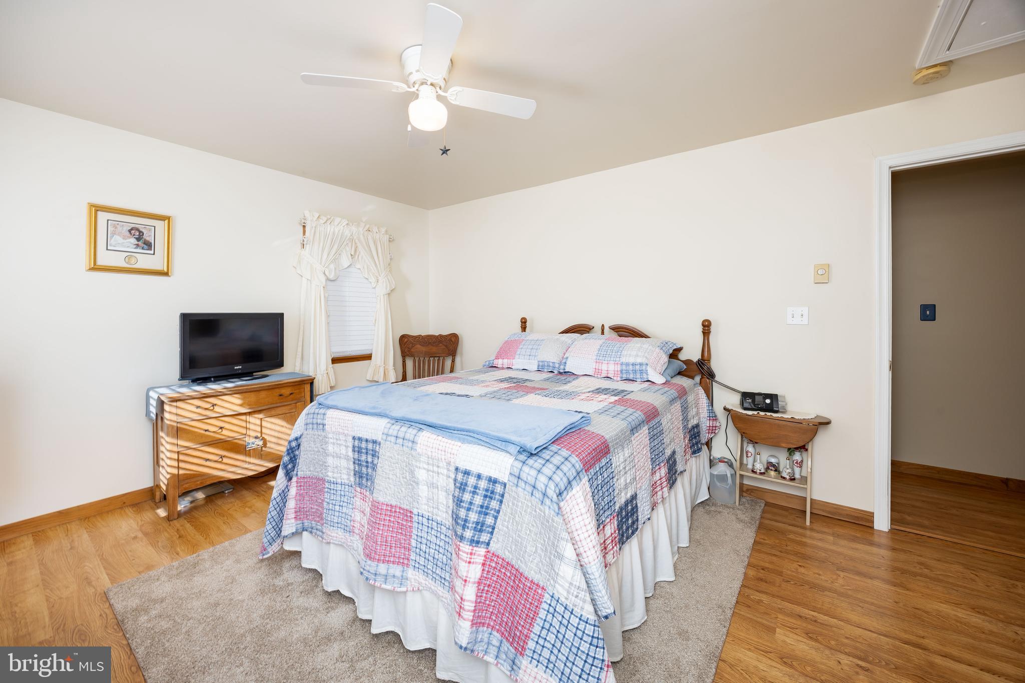 911 Outten Road Salisbury, MD 21804 - Photo 22 of 36 a bedroom with a bed and a chair