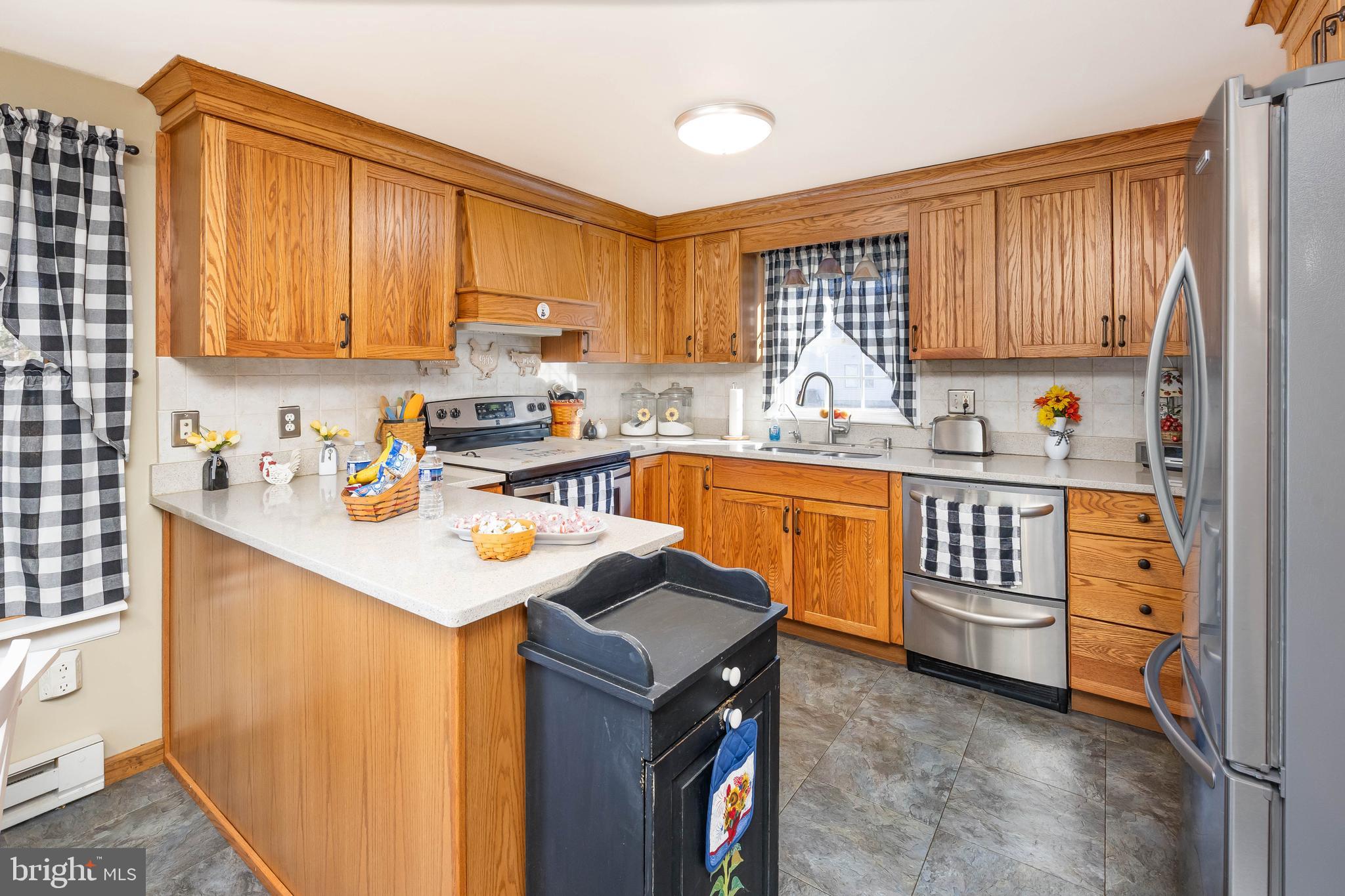 911 Outten Road Salisbury, MD 21804 - Photo 3 of 36 a kitchen with a sink stove and cabinets