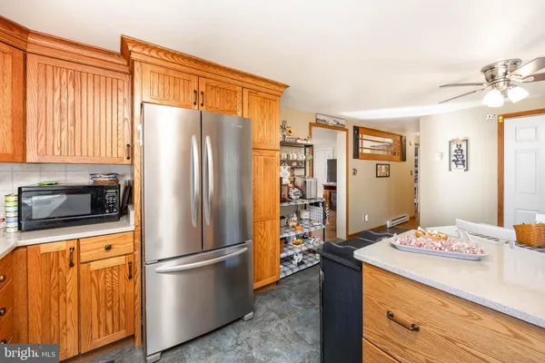 a kitchen with stainless steel appliances a refrigerator and a stove top oven