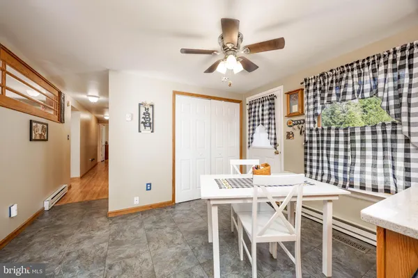 a dining room with furniture and window