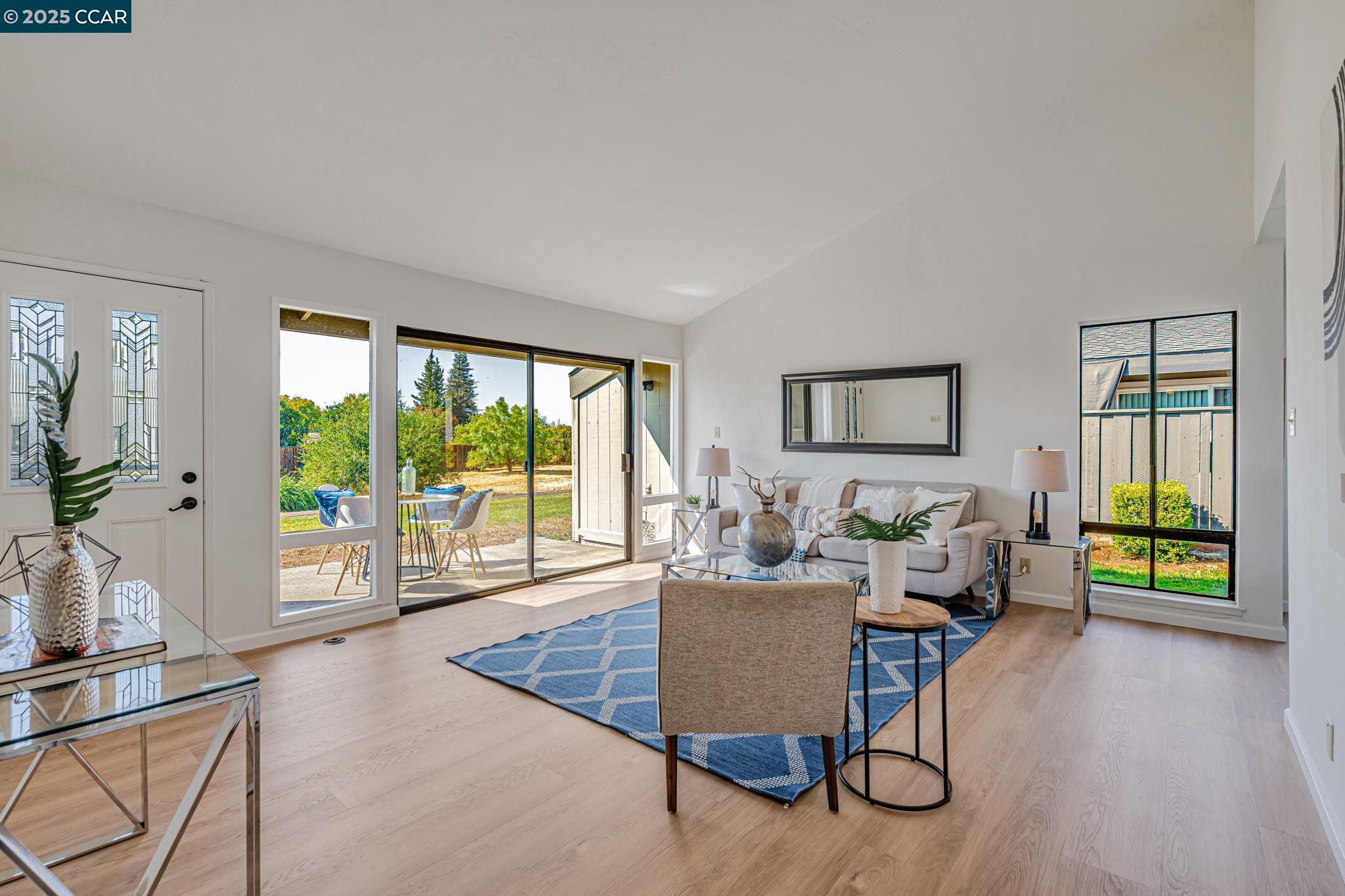 1335 Kenwal Road, Unit A Concord, CA 94521 - Photo 1 of 1 a living room with furniture and a large window