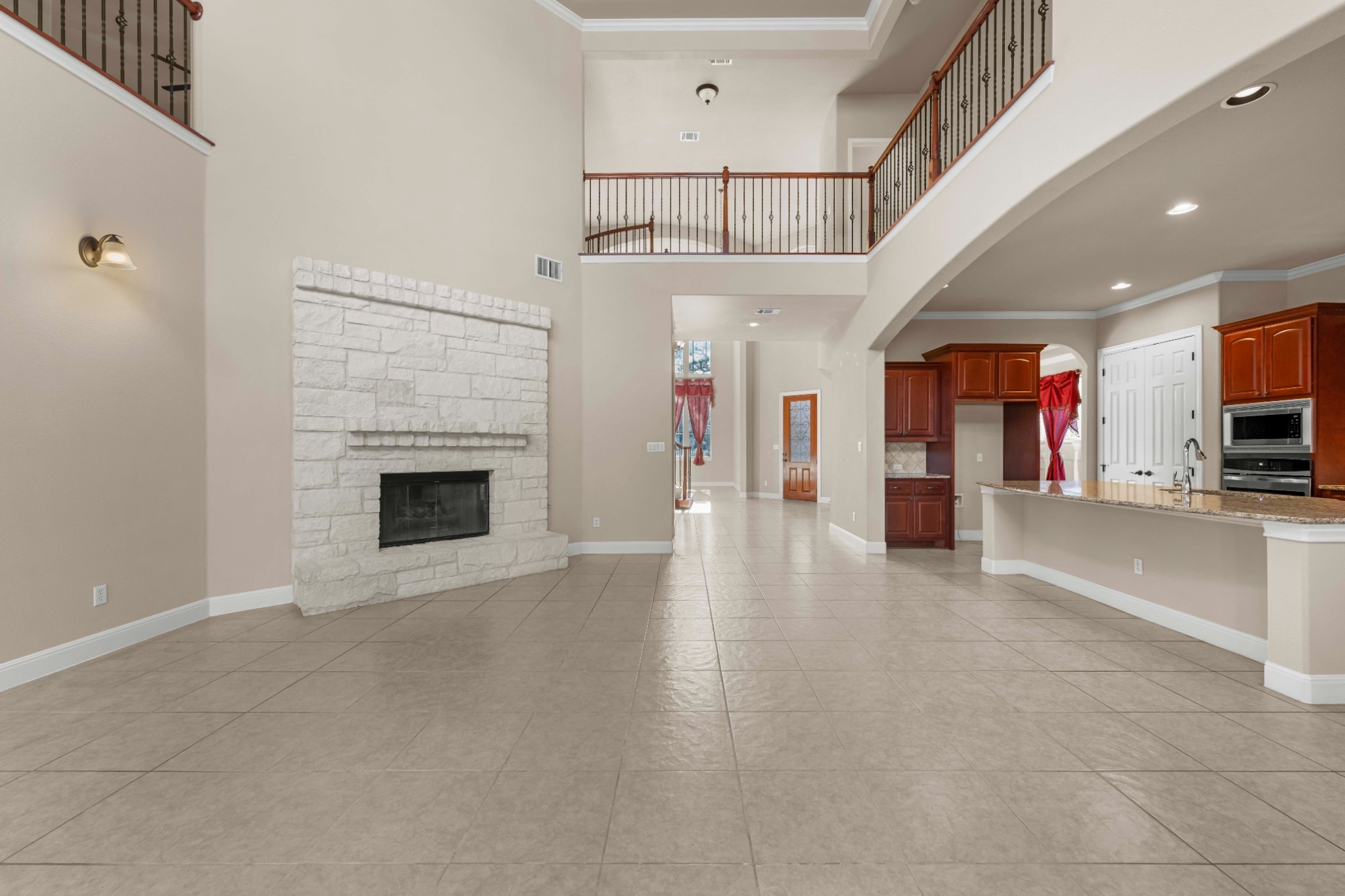 3903 Remington Road Cedar Park, TX 78613 - Photo 6 of 29 A spacious great room offers high ceilings and a white stone fireplace, with a kitchen bar for casual dining.