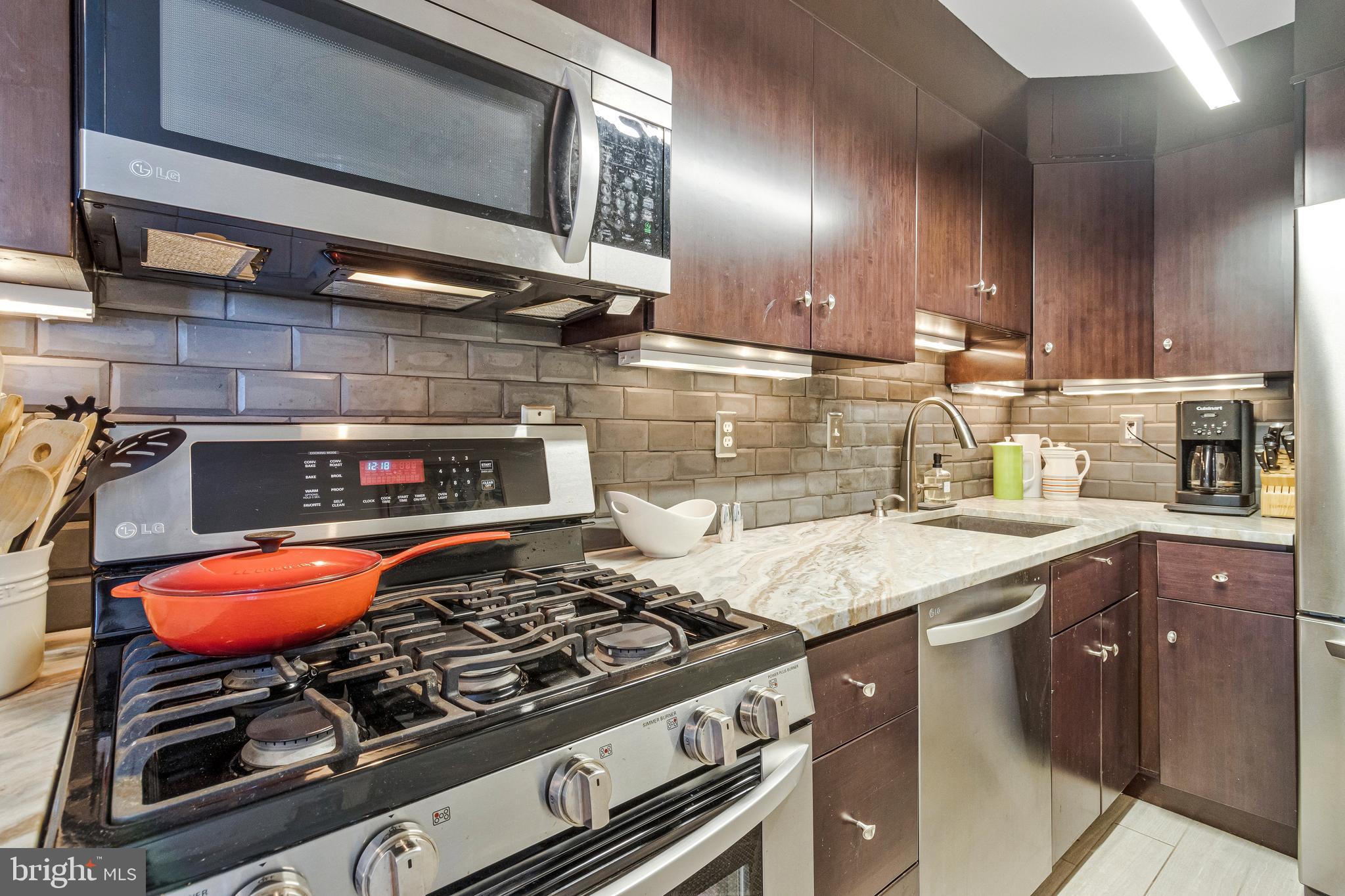 1245 4th Street Southwest, Unit E501 Washington, DC 20024 - Photo 17 of 40 a kitchen with a stove and a sink
