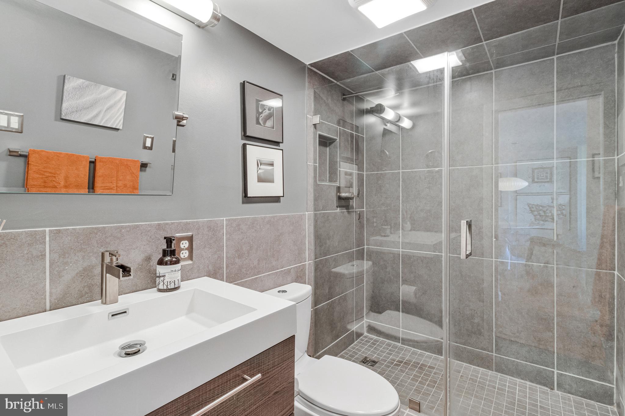 1245 4th Street Southwest, Unit E501 Washington, DC 20024 - Photo 22 of 40 a bathroom with a sink toilet and shower