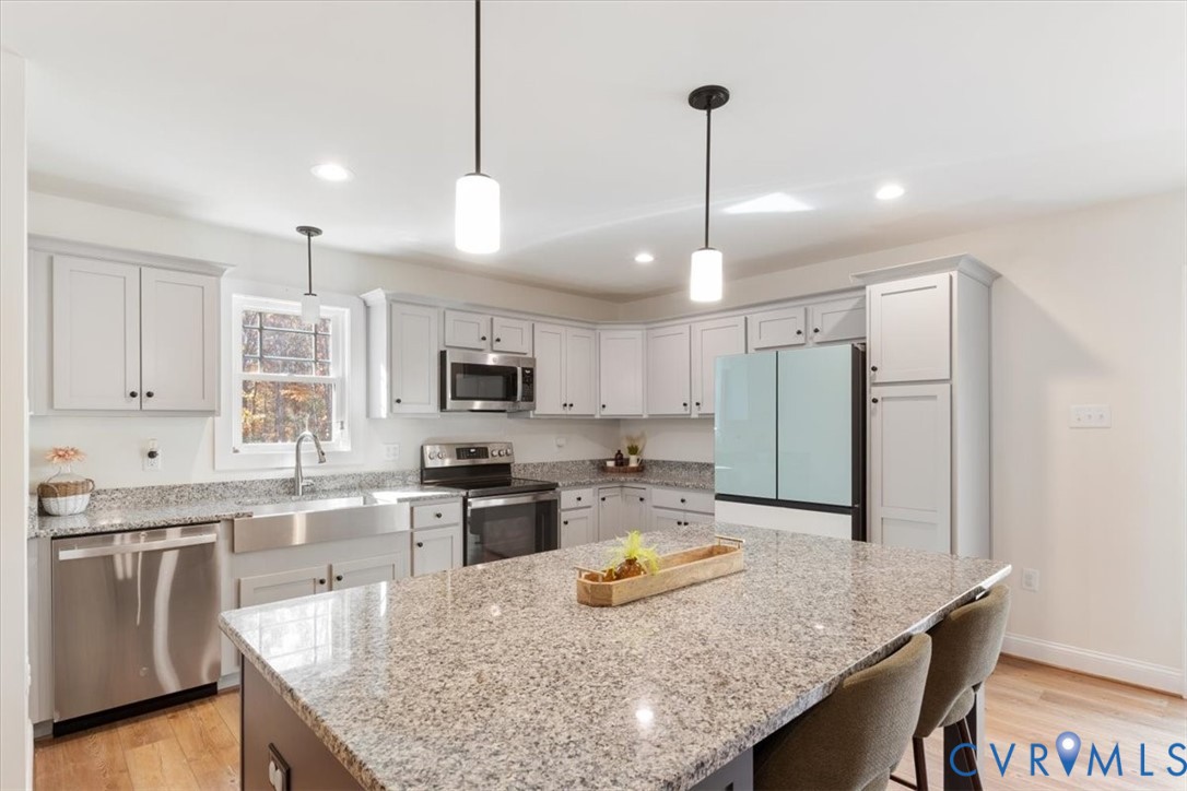 2715 Ballsville Road Powhatan, VA 23139 - Photo 12 of 30 Kitchen with stainless steel appliances, light woo