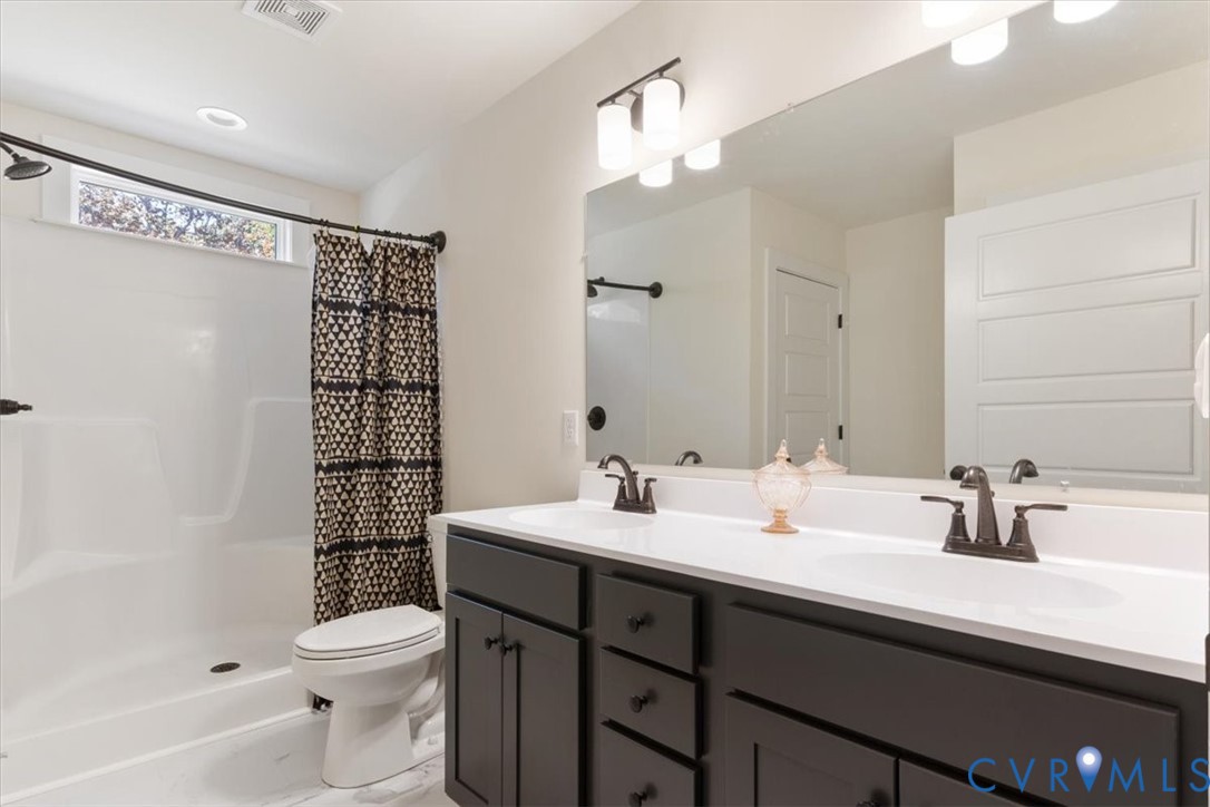 2715 Ballsville Road Powhatan, VA 23139 - Photo 20 of 30 Full bath with double vanity, a stall shower, and