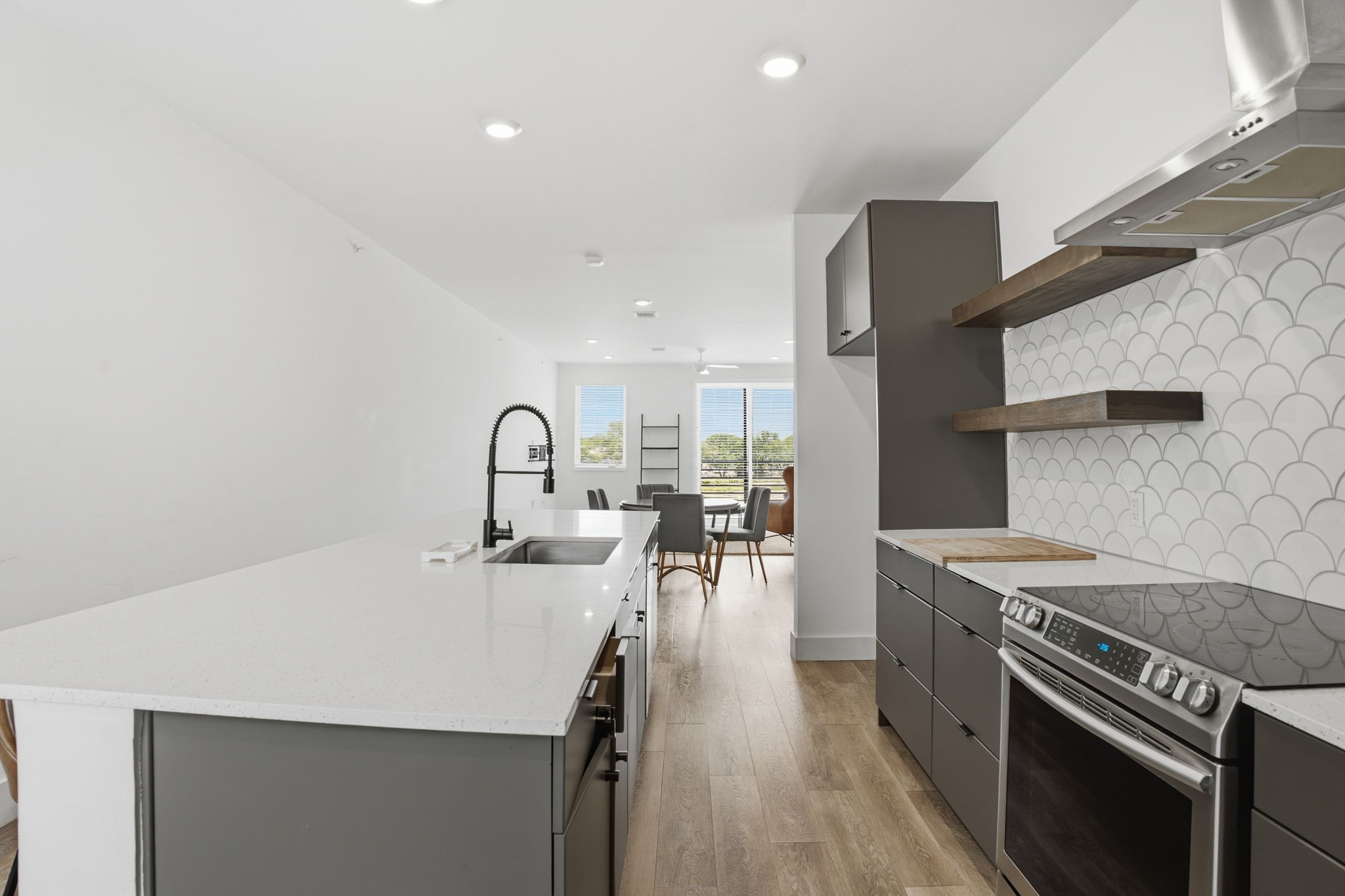 2709 East 5th Street, Unit 1306 Austin, TX 78702 - Photo 3 of 28 A pristine culinary space with sleek cabinetry and a convenient island sink.