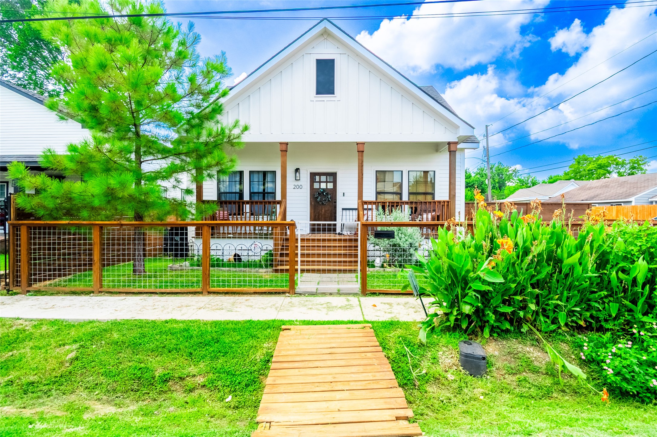 200 Carl Street Houston, TX 77009 - Photo 3 of 32 a front view of a house with a yard and potted plants