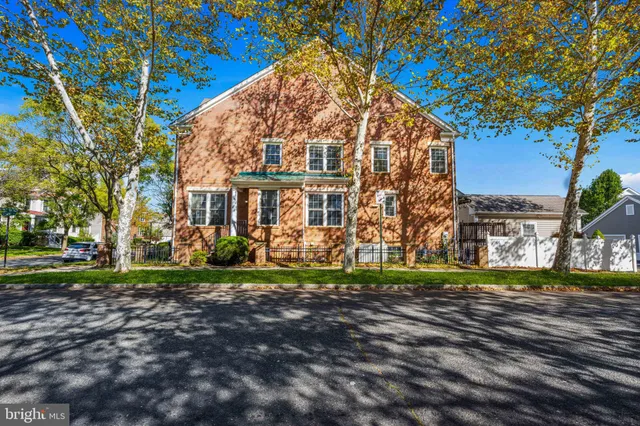 a kitchen with stainless steel appliances wooden floors and large window