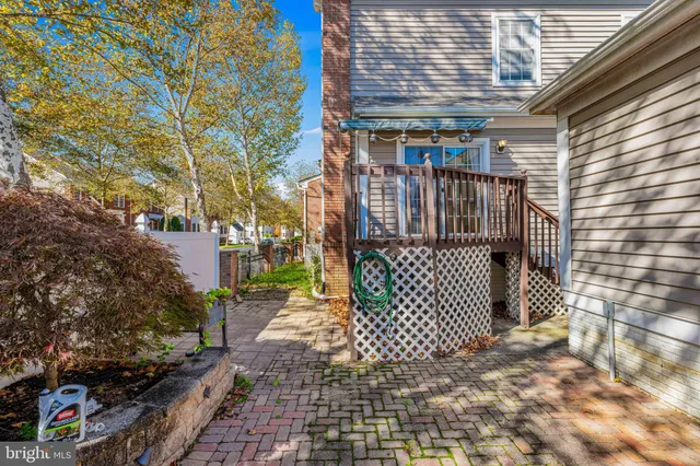 a kitchen with granite countertop wooden floors stainless steel appliances and sink