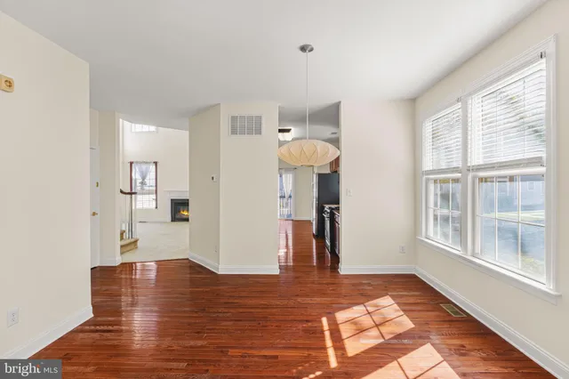a view of a livingroom with an empty space and a window