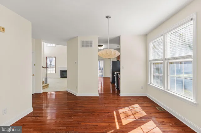 a view of a livingroom with an empty space and a window