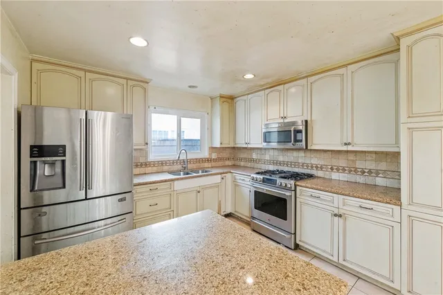 a large kitchen with cabinets and stainless steel appliances