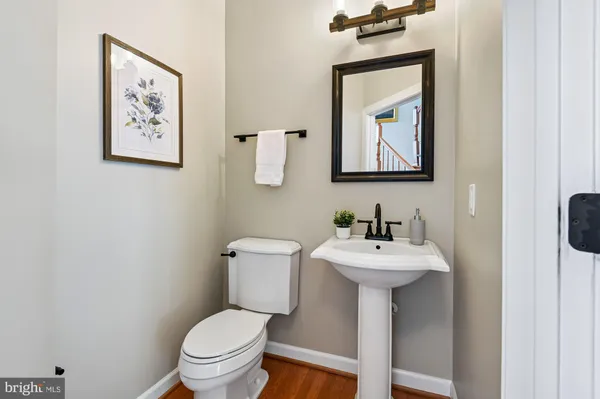 a bathroom with a toilet a sink and mirror