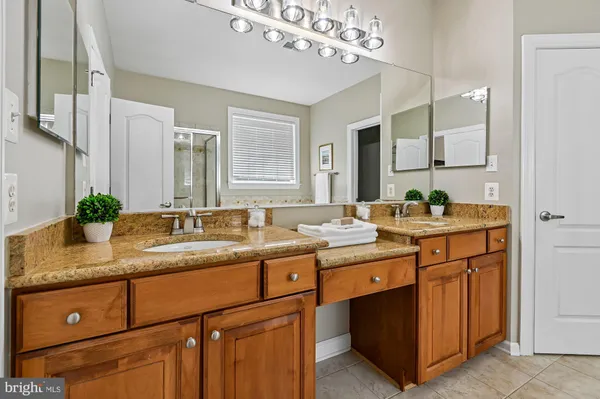 a bathroom with a sink double vanity and a mirror