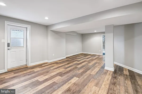 a view of a room with wooden floor