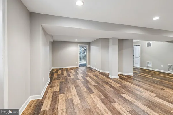 a view of a room with wooden floor