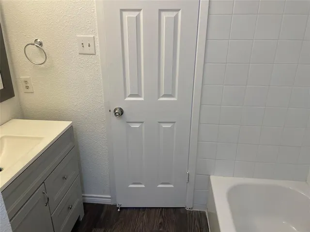 a bathroom with a granite countertop sink