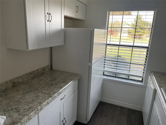 a view white cabinets and a wooden floor