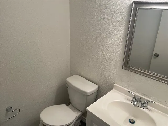 a white toilet sitting next to a bathroom sink