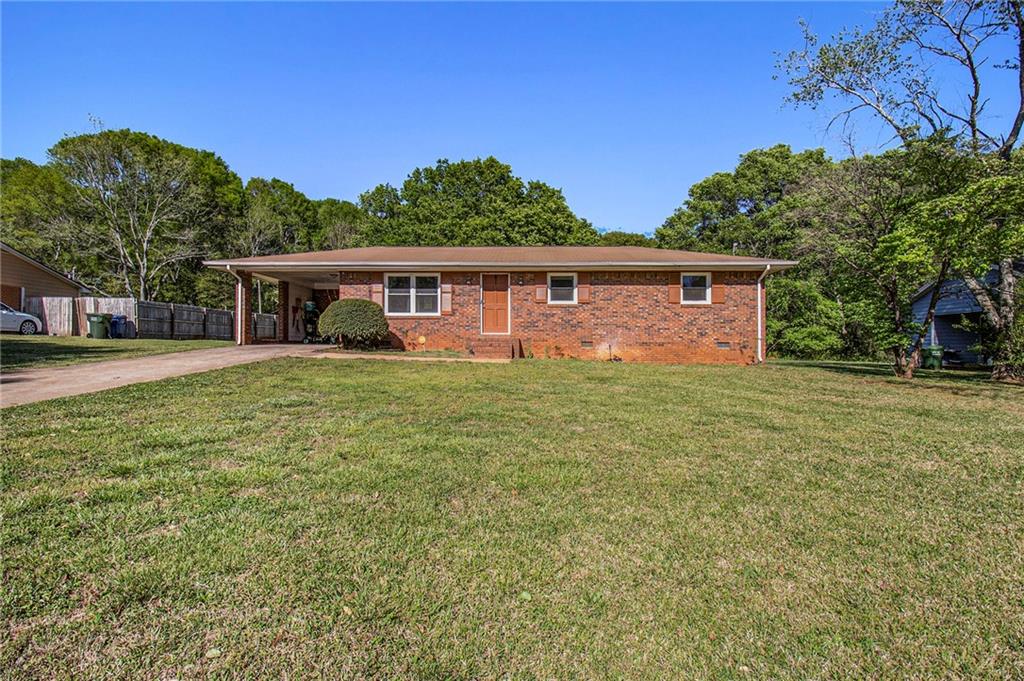 1229 Fairview Drive Monroe, GA 30656 - Photo 1 of 1 a view front of house with yard and trees in the background